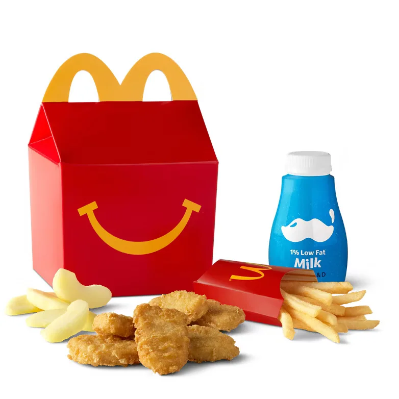 [vc_row height="small"][vc_column width="1/1"][vc_column_text] 6 Piece Chicken McNuggets Happy Meal [/vc_column_text][vc_row_inner content_placement="middle"][vc_column_inner width="1/2"][us_image image="365" link="%7B%22url%22%3A%22%22%7D"][/vc_column_inner][vc_column_inner width="1/2"][vc_column_text] Kids love this classic meal. It comes with 6 crispy Chicken McNuggets. Each nugget is tender inside. The coating is golden and crunchy. Made with white meat chicken. Cooked fresh to order. The meal includes a side. Choose fries or apple slices. Both options are kid-friendly. Fries are salted and crispy. Apple slices are fresh and light. A drink comes with the meal. Pick from milk, juice, or soda. Small sizes fit little hands. Every choice is easy to make. This meal also includes a toy. Toys change often and stay fun. Kids enjoy the surprise each time. It adds excitement to mealtime. The meal comes in a bright box. It's designed just for kids. Easy to carry and open. Perfect for lunch or dinner. [/vc_column_text][/vc_column_inner][/vc_row_inner][/vc_column][/vc_row][vc_row height="small"][vc_column width="1/1"][vc_column_text] Nutritional Information [/vc_column_text][us_separator size="custom" height="20px"][vc_column_text] 475 Cal. Calories 24g Protein 45g Total Carbs (16% DV) 22g Total Fat (29% DV) Saturated Fat: 4.5g (23% DV) Total Sugars: 14g Iron: 1.0mg (6% DV) Trans Fat: 0g Added Sugars: 0g (0% DV) Potassium: 825mg (16% DV) Cholesterol: 50mg (17% DV) Vitamin D: 2mcg (15% DV) Sodium: 670mg (29% DV) Dietary Fiber: 1g (7% DV) Calcium: 286mg (20% DV) 6 Piece Chicken McNuggets Happy Meal